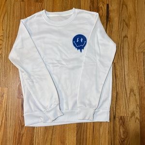 White crew neck with blue smile faces only worn once